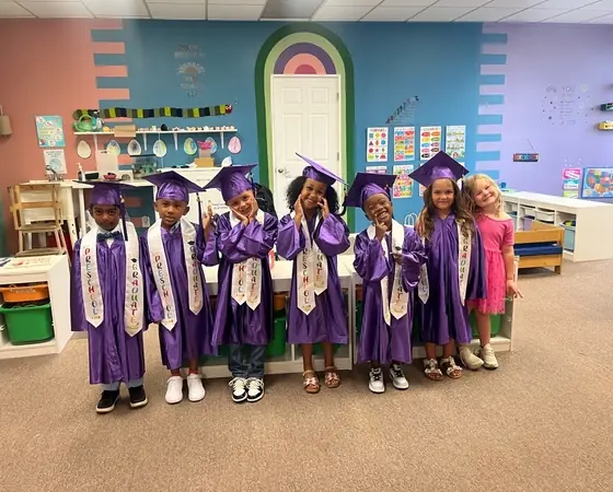 Preschool graduates in caps and gowns at Chatter Splatter Daycare